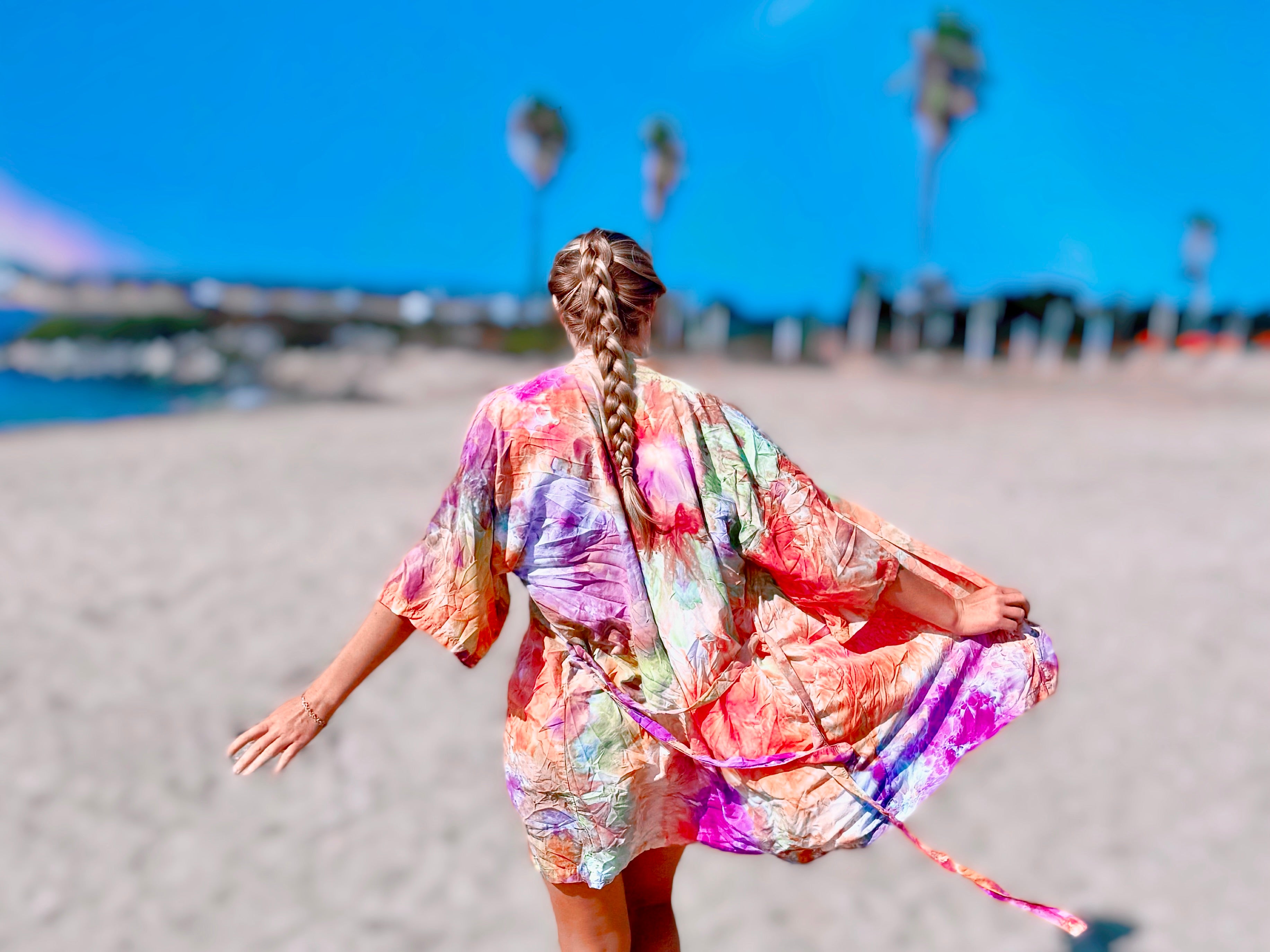 OB Tie Dye hand ice-dyed kimono robe in orange, purple & green rainbow colors, beach lifestyle photo shoot in Mission Bay San Diego