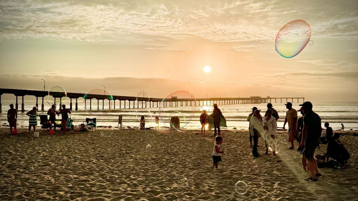 Bubbles floating over the Ocean Beach pier at sunset