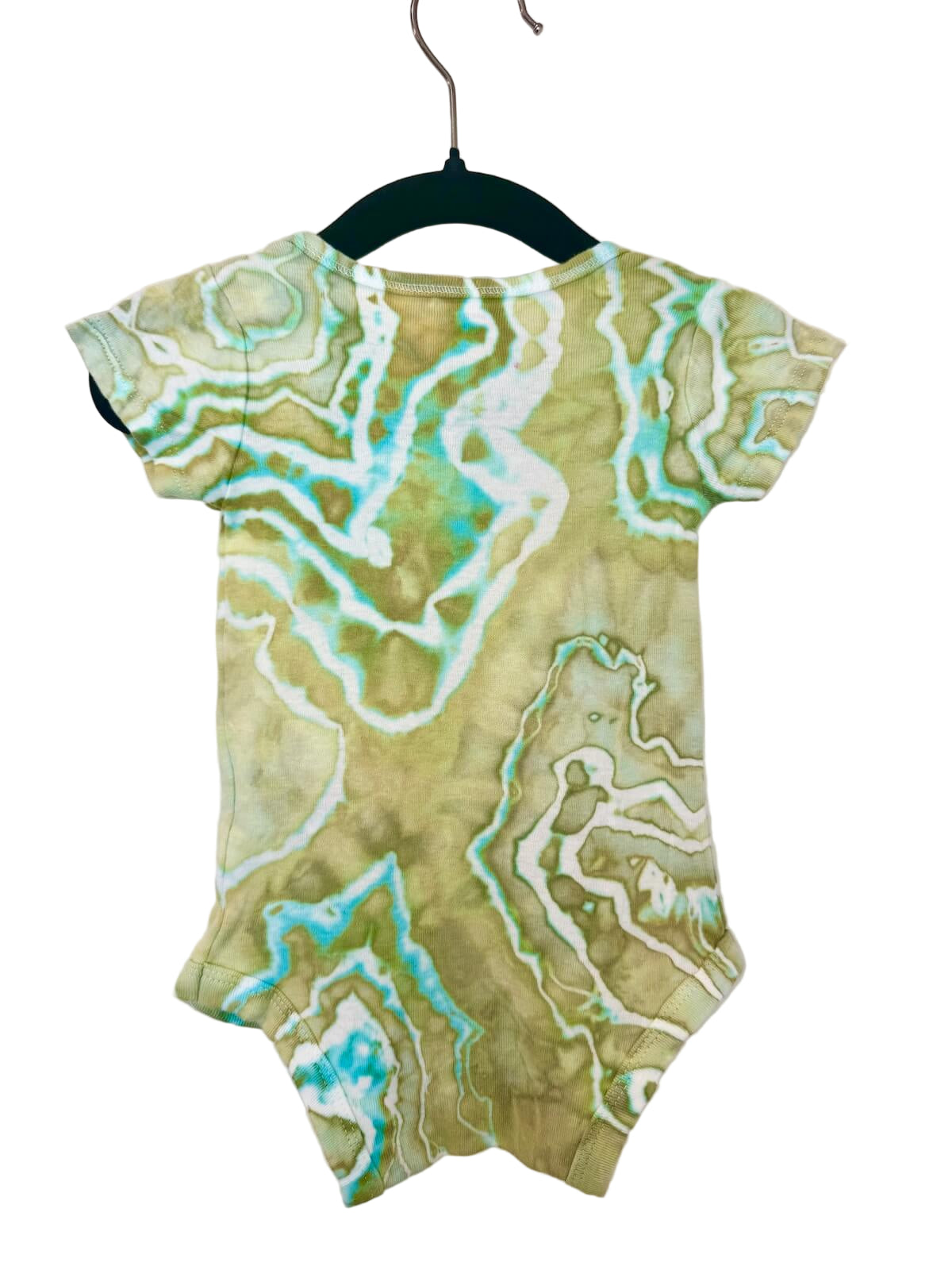 Back of green, turquoise and white patterned baby romper on a hanger against a white background