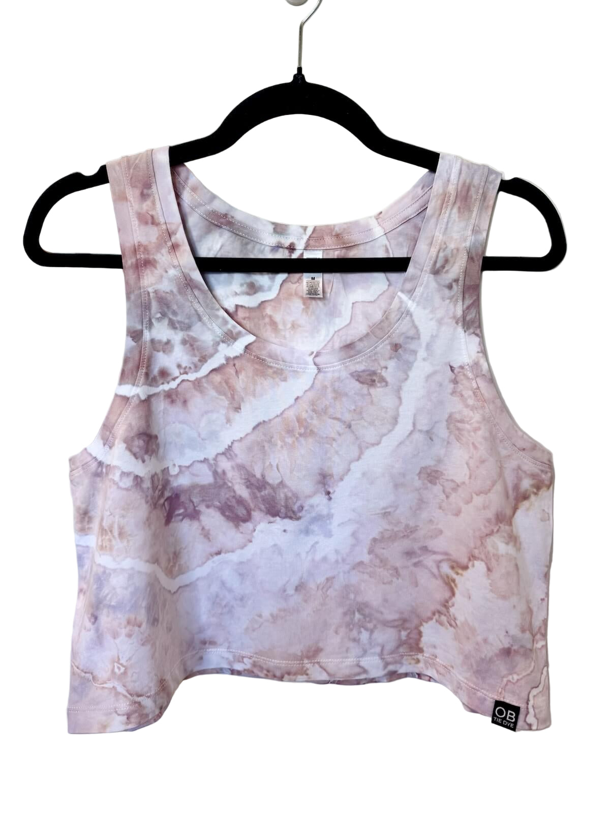 Front view of muted pink and white hand ice-dyed womens crop tank with soft marbled pattern