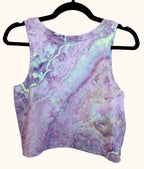 Back view of lavender purple and light green uv reactive hand ice-dyed woman's crop tank with fluid, watercolor texture
