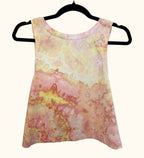 Back view of orange and yellow sunset tones hand ice-dyed woman's crop tank with fluid, watercolor texture