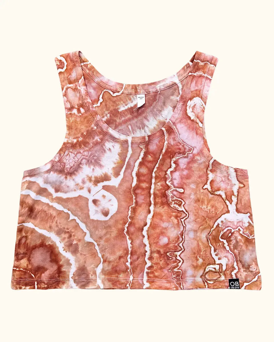 Front view of a hand ice-dyed women's crop tank in Sunset Cliffs orange and brown tones
