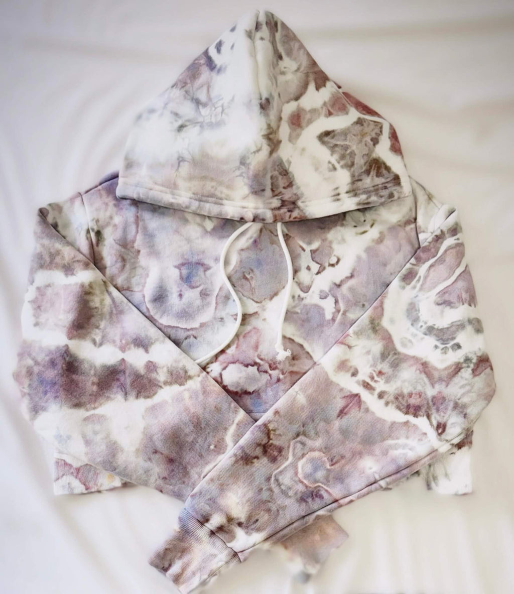 Marbled ice dyed white and purple cropped hoodie on a white background