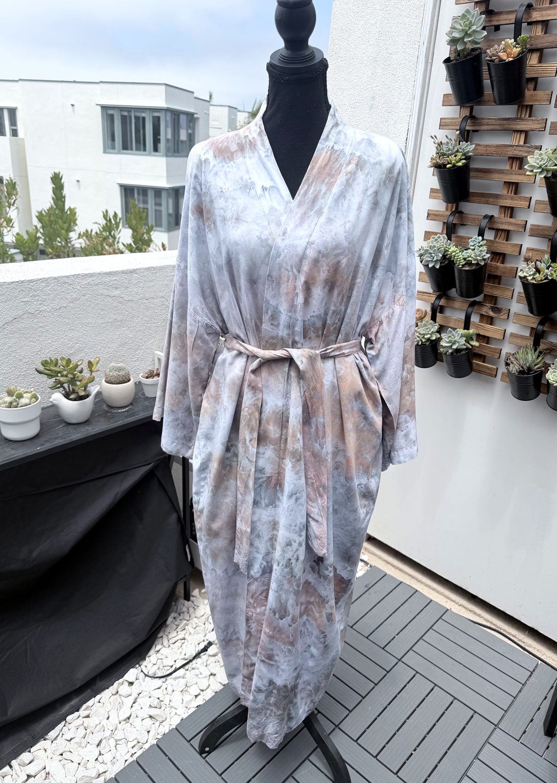 Long hand ice-dyed kimono robe in soft stone grey and sand tones, shown on a mannequin