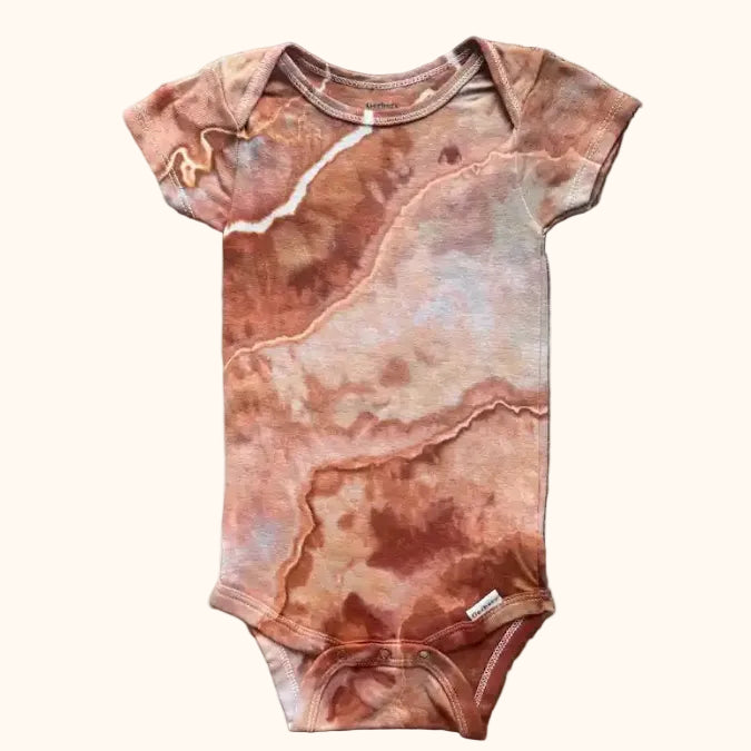Hand-dyed ice dye baby onesie with organic, coastal-inspired color pattern