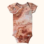 Hand-dyed ice dye baby onesie with organic, coastal-inspired color pattern