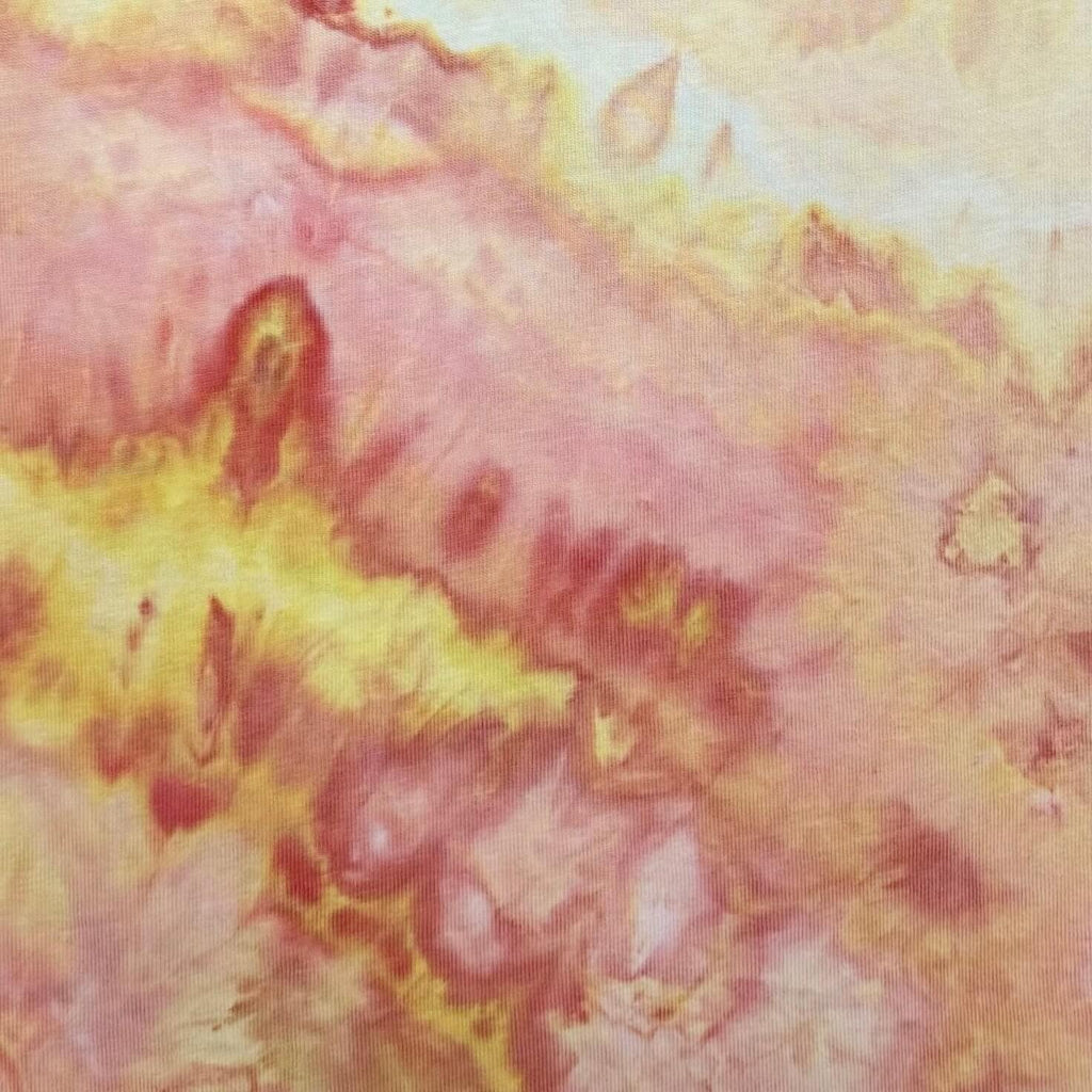 Sunrise tie-dye colorway swatch with blended peach, blush, red, orange, and soft yellow tones, hand ice-dyed by OB Tie Dye.