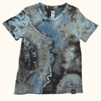 Front view of a kids’ OB Tie Dye shirt with blue, green, and brown geode-style ice-dye patterns.