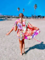 Woman in a colorful OB Tie Dye hand ice-dyed kimono robe, vertical  beach lifestyle photo shoot in San Diego