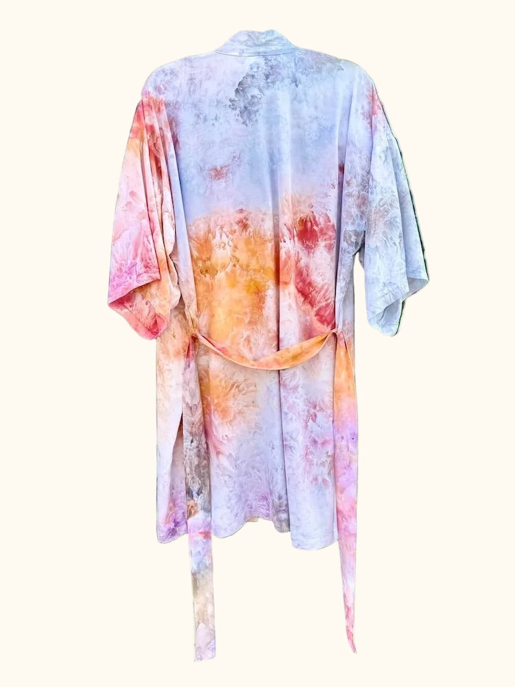 Back view of an OB Tie Dye kimono featuring orange, pink, grey, and white sunset-inspired ice-dye tones.