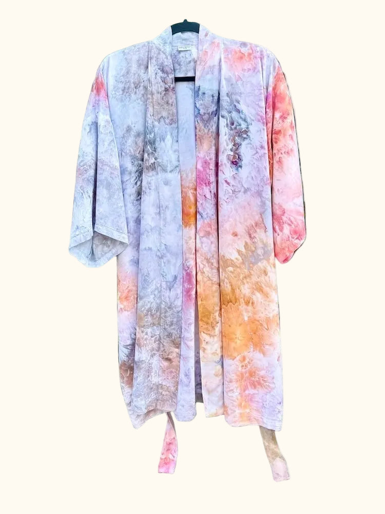 Front view of an OB Tie Dye kimono in soft pink, orange, grey, and white with an open drape.